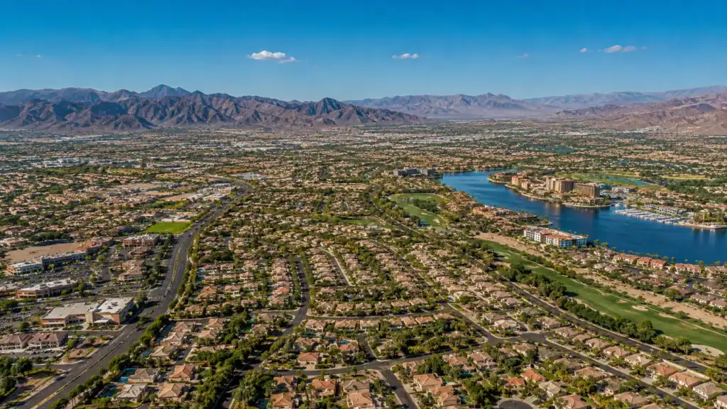Aerial daytime view of Henderson Nevada showing master-planned neighborhoods, Lake Las Vegas resort community, and mountain backdrop