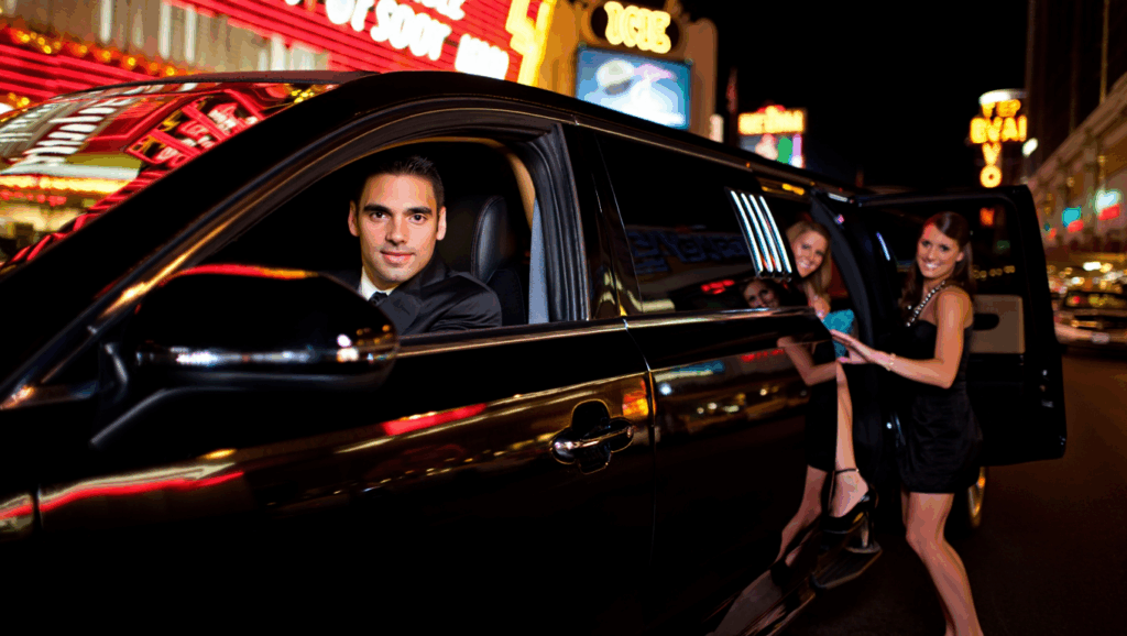 Black Lincoln Mkt Limousine (8 10 Pax) With Driver Chauffeur Wearing A Suit And Passengers Leaving From The Back Seat Dropping Them Off In Las Vegas At The Bachelorette Party