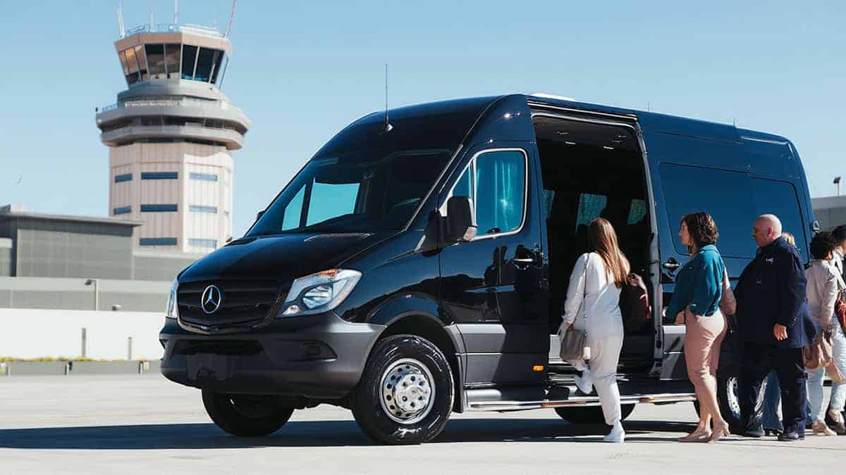 Black Sprinter With Passengers Boarding Airport Shuttle