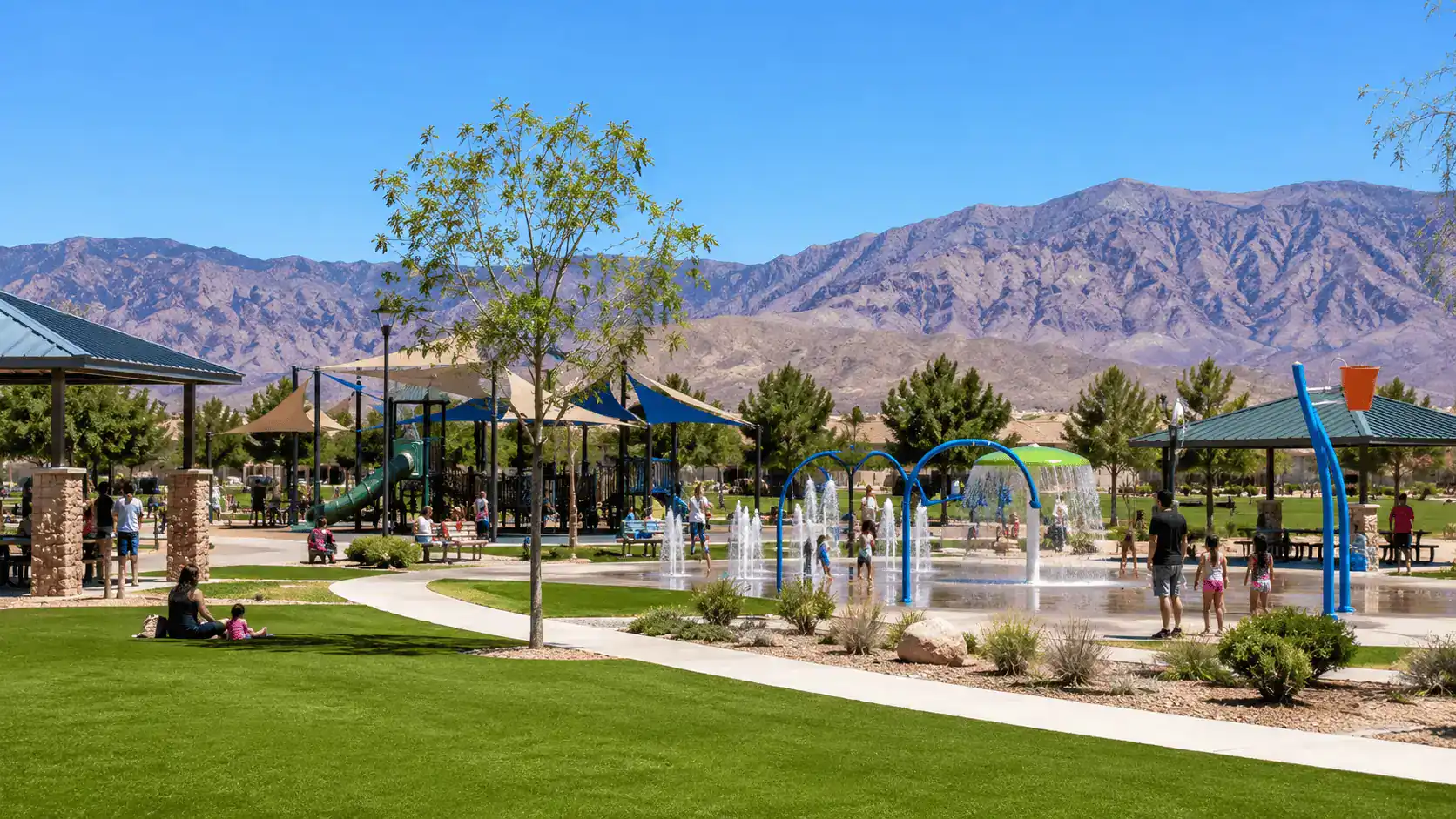 Centennial Hills Park Splash Pad Playground Northwest Las Vegas Family Recreation – Personal Sedan Services A large suburban community park in Centennial Hills Las Vegas with green lawns, a children's splash pad, playground, and desert mountains in the background