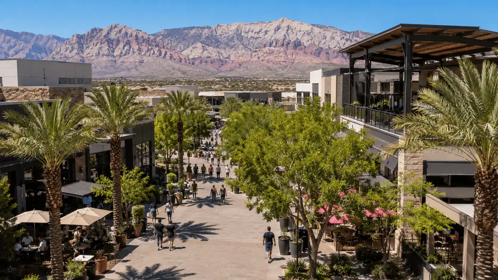 Downtown Summerlin open-air shopping and dining district with modern architecture, pedestrian walkways, and red rock mountains in the background