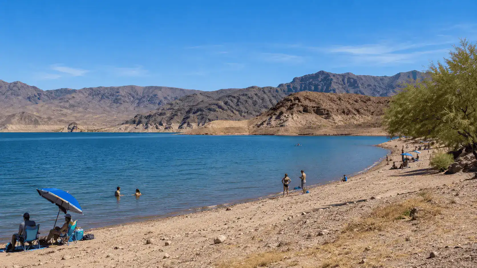 Lake Mead Boulder Beach Swimming Desert Shoreline Near Whitney Nevada – Personal Sedan Services Lake Mead's Boulder Beach with blue water and a sandy desert shoreline near Whitney Nevada, about 30 minutes away by car