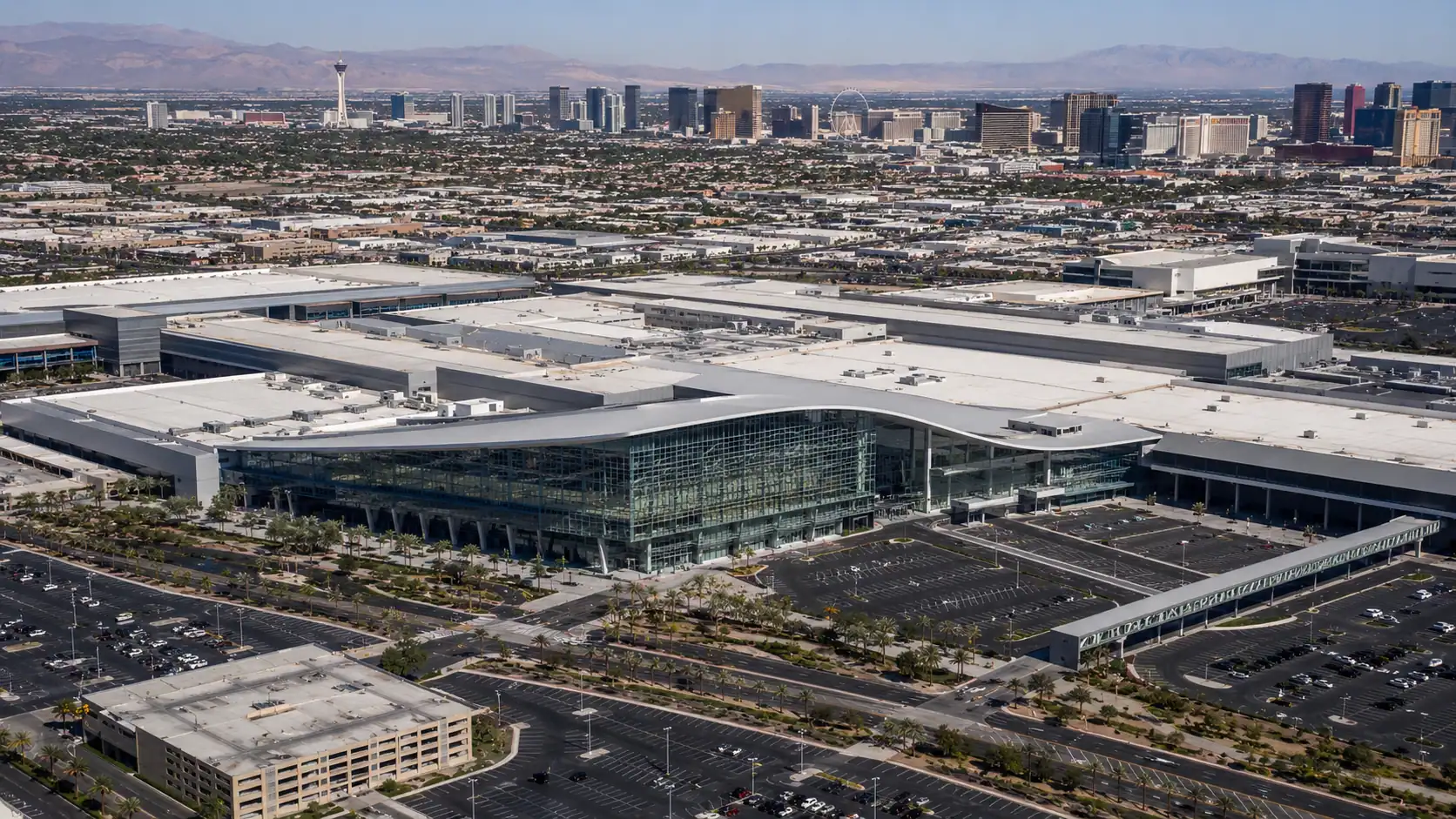 Aerial daytime view of the Las Vegas Convention Center campus showing the West Hall glass facade and multiple convention halls demonstrating the scale of Las Vegas convention infrastructure