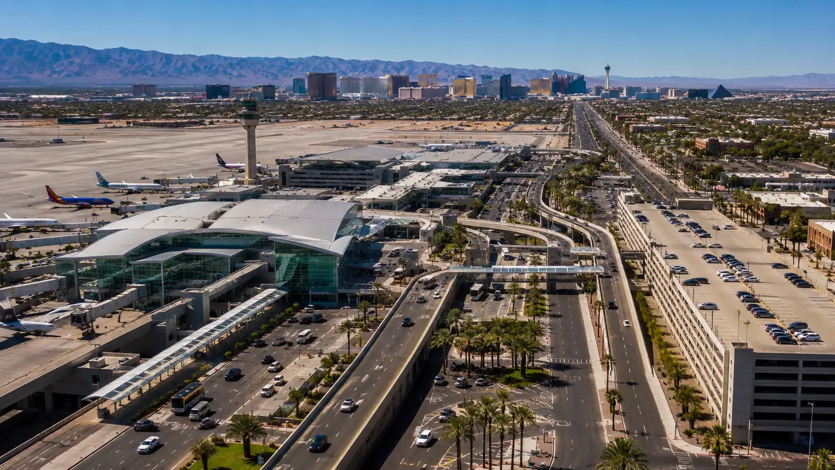 Aerial daytime view of Harry Reid International Airport Las Vegas with the Strip visible 3 miles to the north showing the airport-to-Strip transportation corridor that Las Vegas transportation statistics describe