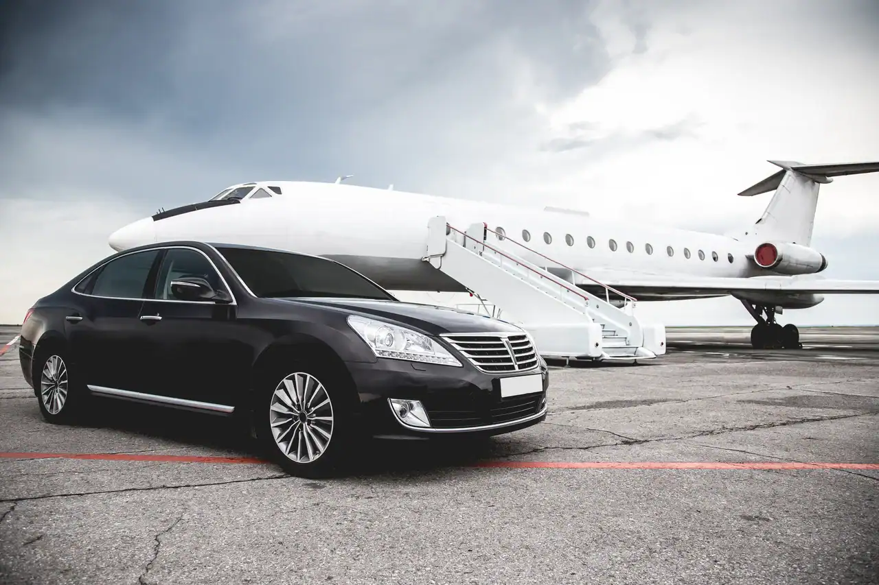 Professional chauffeur greeting an arriving passenger for a Las Vegas airport shuttle transfer - Personal Sedan Services