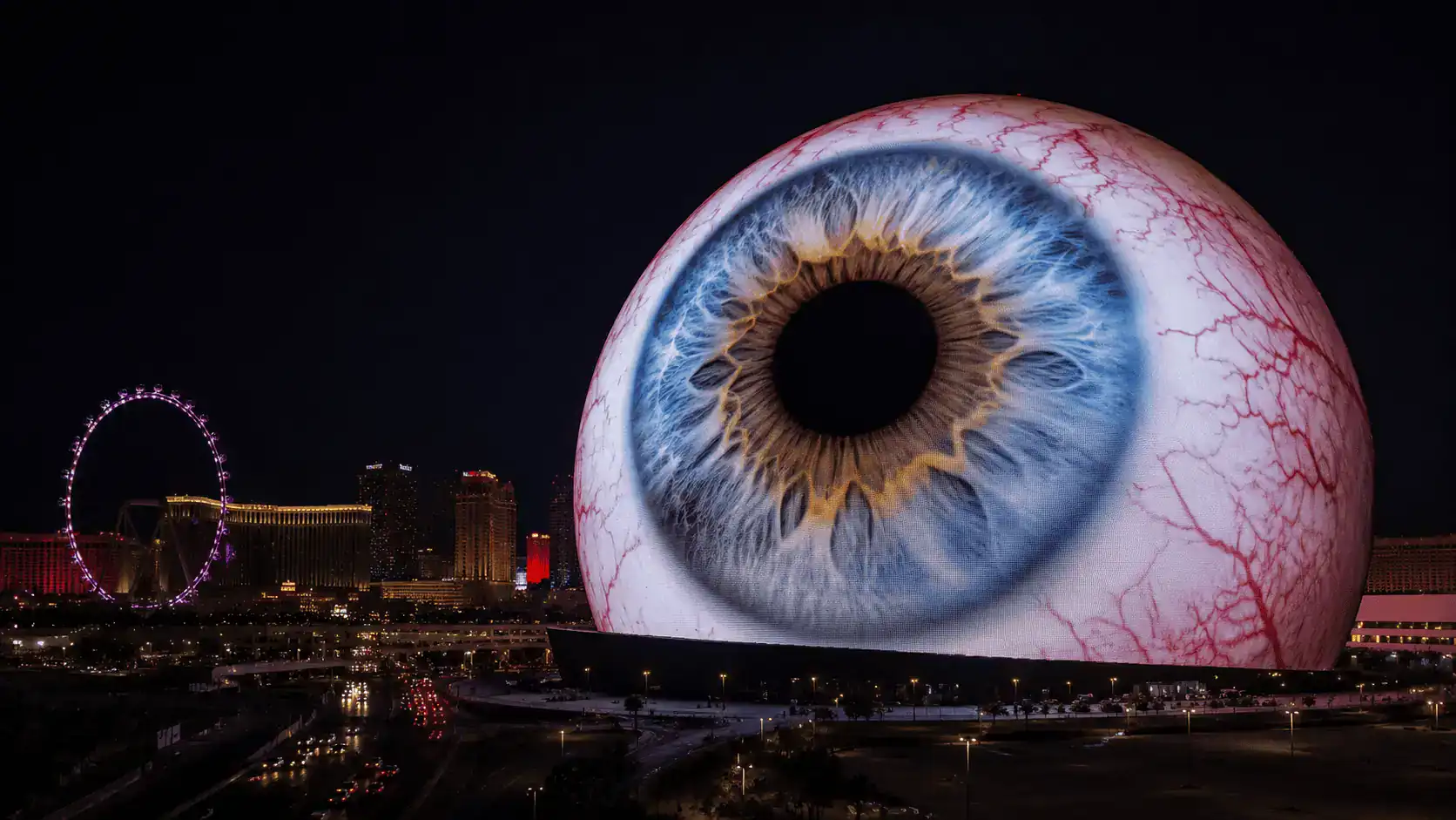 Sphere Las Vegas Exterior Giant Eyeball LED Display Night Strip Landmark – Personal Sedan Services The exterior of the Sphere Las Vegas displaying a giant eyeball graphic across its LED surface at night with the Las Vegas Strip nearby