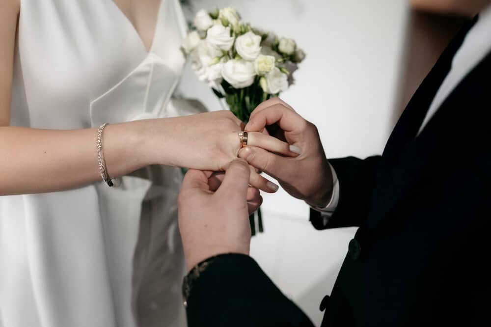 Couple exchanging rings at a Las Vegas wedding ceremony - Personal Sedan Services