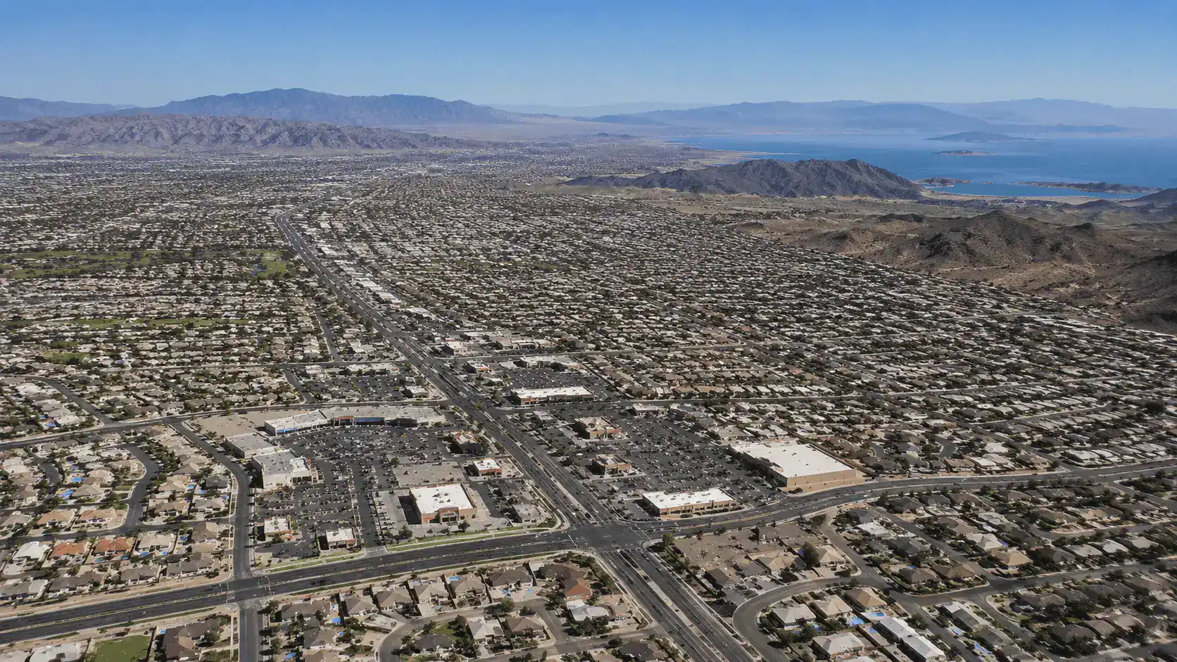 Aerial daytime view over Whitney Nevada in east Las Vegas with residential neighborhoods, the Boulder Highway corridor, Henderson to the south and Lake Mead in the far distance