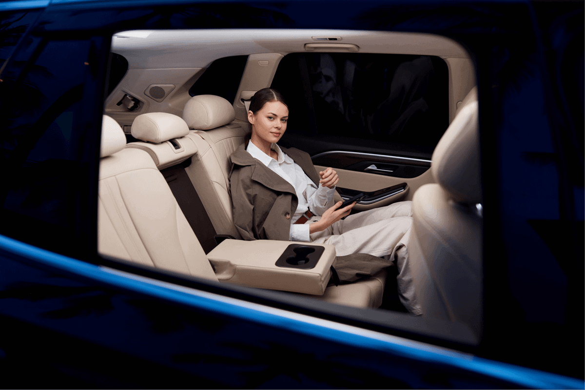 Woman Sitting In The Back Seat Of A Black Car At Night.jpg