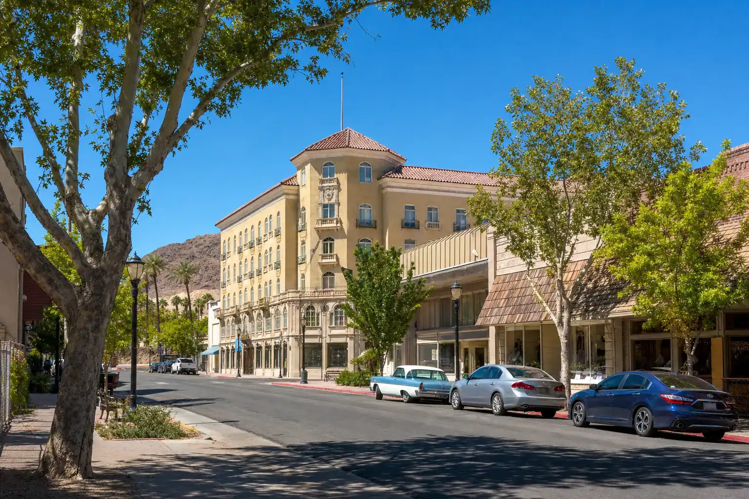 Boulder City Historic District Downtown Boulder Dam Hotel Vintage Main Street Nevada – Personal Sedan Services The historic downtown of Boulder City Nevada with the 1933 Boulder Dam Hotel, vintage storefronts, and tree-lined streets
