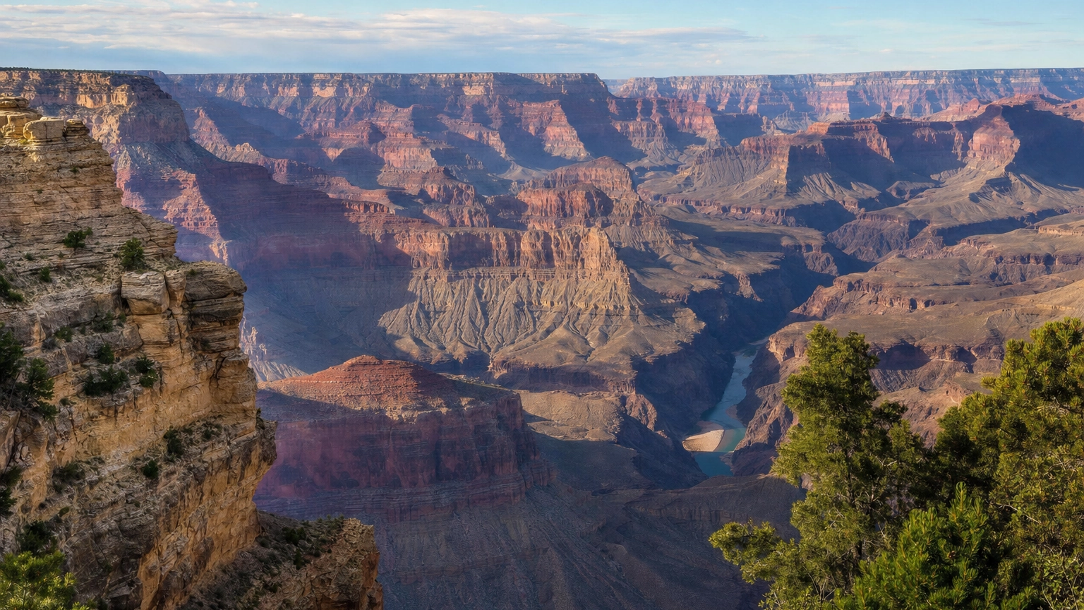 Layered red and orange canyon walls receding into blue haze at the Grand Canyon South Rim near Mather Point