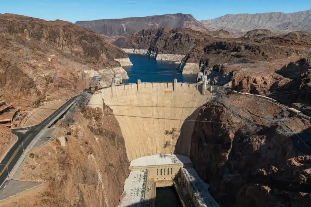 Hoover Dam viewed from the memorial bridge near Boulder City Nevada with Lake Mead and the Black Canyon walls under a blue sky