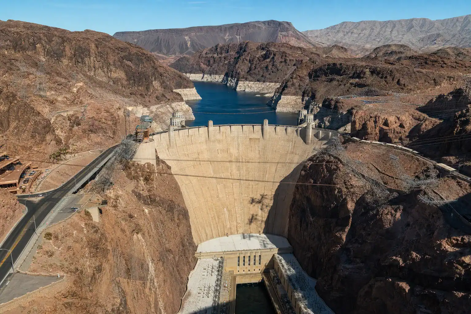 Hoover Dam viewed from the memorial bridge near Boulder City Nevada with Lake Mead and the Black Canyon walls under a blue sky