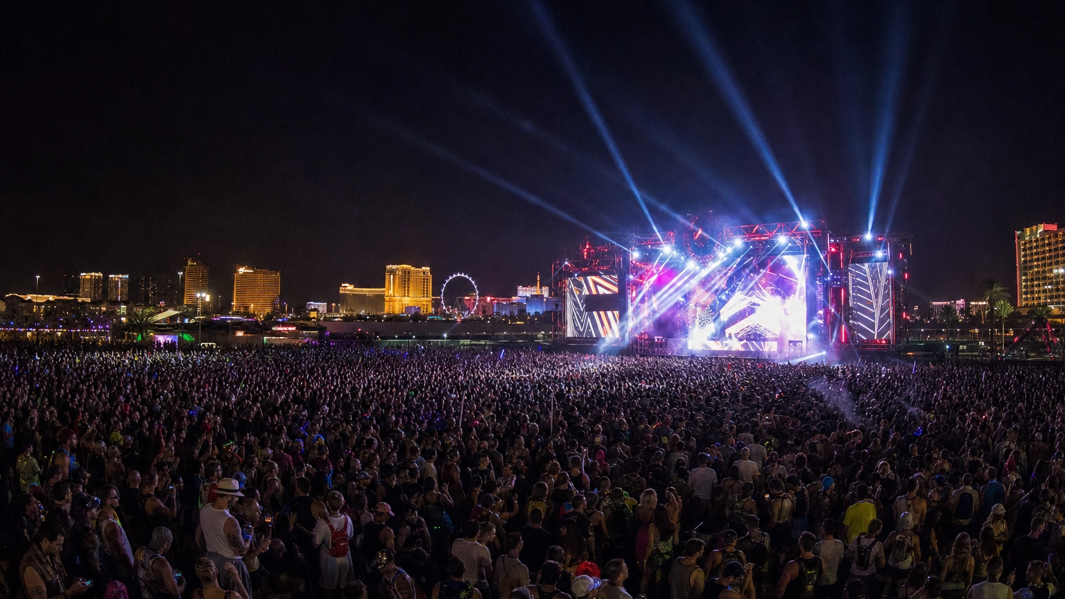 Large nighttime festival crowd facing a lit main stage at an open outdoor Las Vegas venue