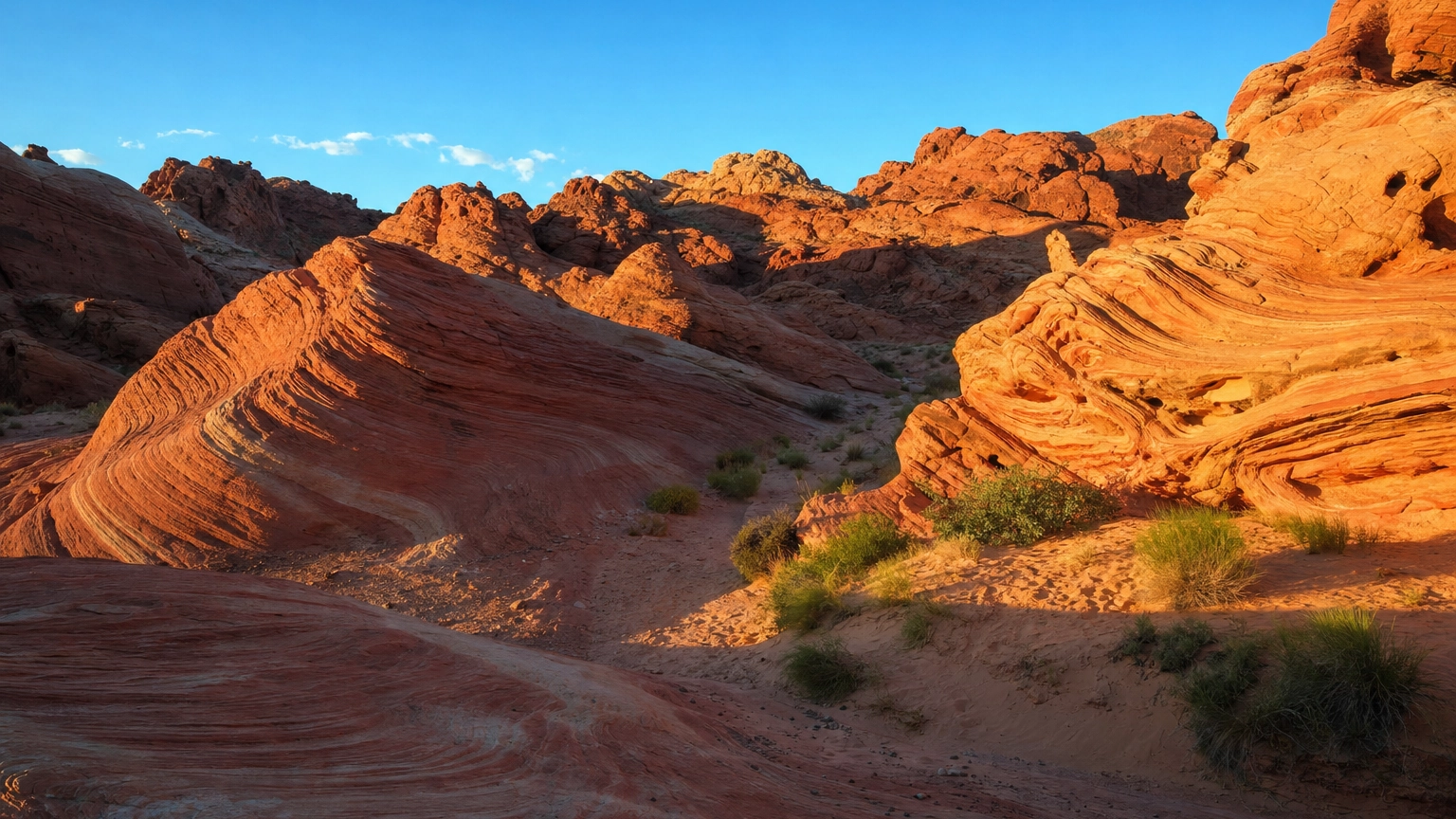 Fiery red swirled Aztec sandstone formations glowing at Valley of Fire State Park near Las Vegas at golden hour